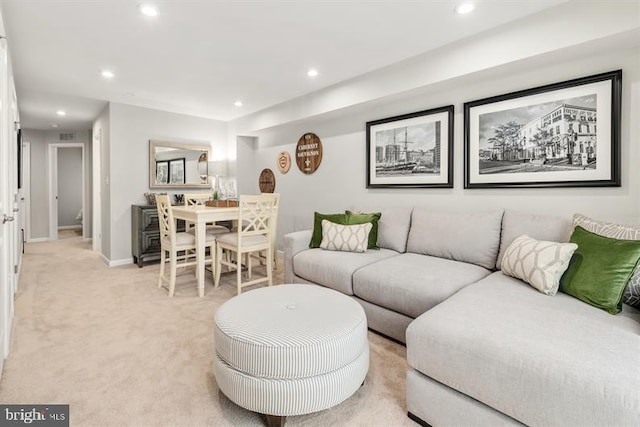 living area featuring recessed lighting, baseboards, and light carpet