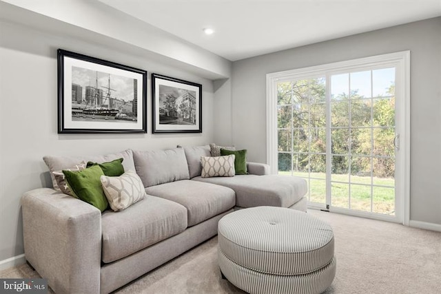 carpeted living room featuring baseboards