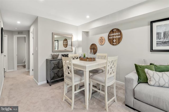 dining space featuring visible vents, recessed lighting, light colored carpet, and baseboards