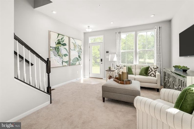 carpeted living area with recessed lighting, baseboards, a healthy amount of sunlight, and stairs