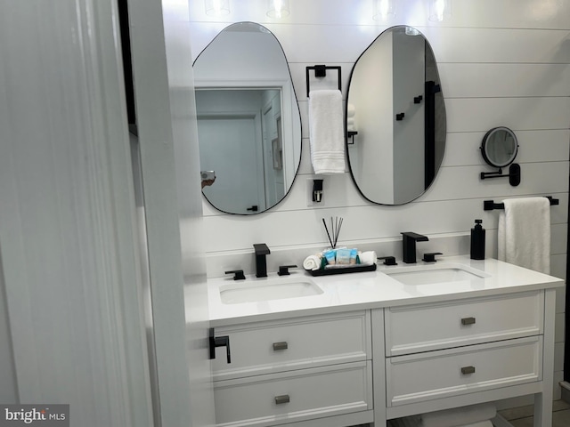 full bath featuring double vanity and a sink