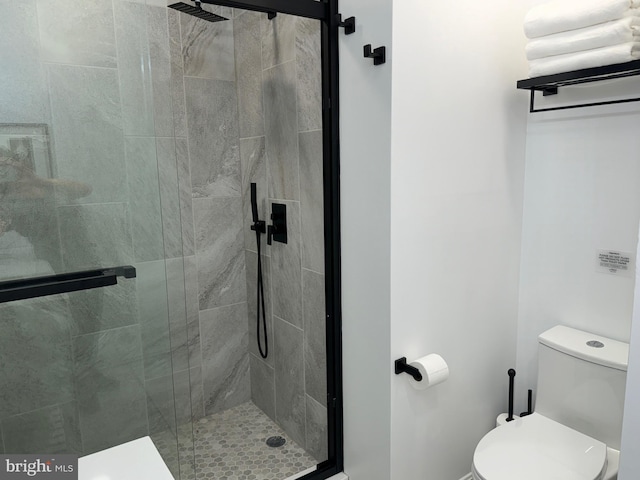 full bath featuring a shower stall and toilet