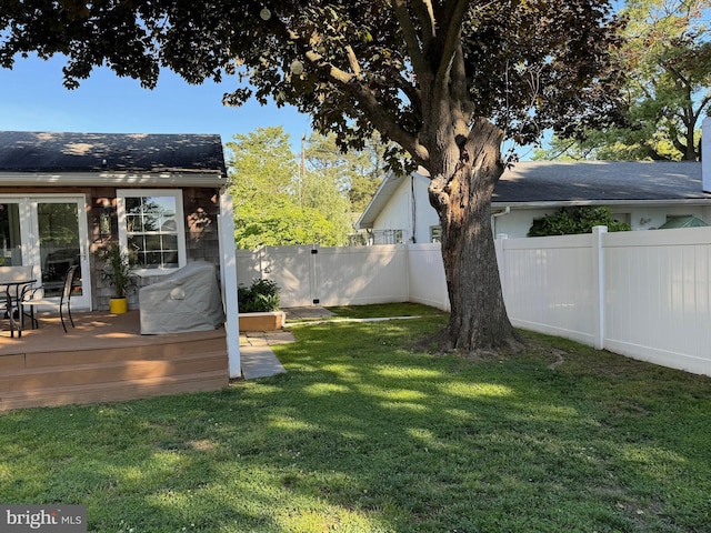 view of yard featuring a deck and a fenced backyard