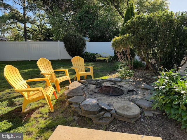 view of yard featuring an outdoor fire pit and fence