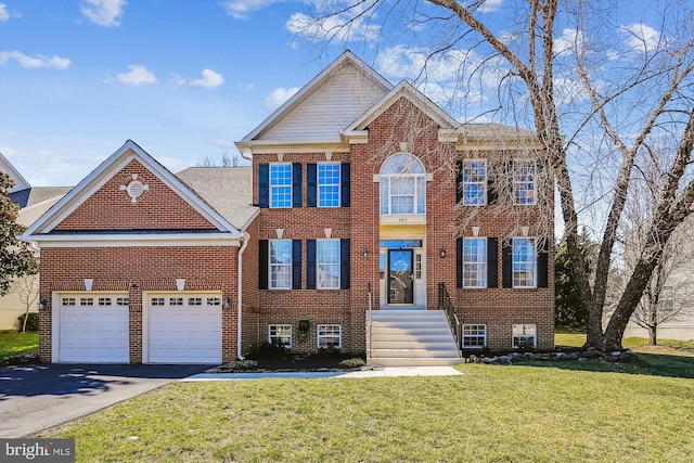 view of front facade with aphalt driveway, an attached garage, brick siding, and a front lawn