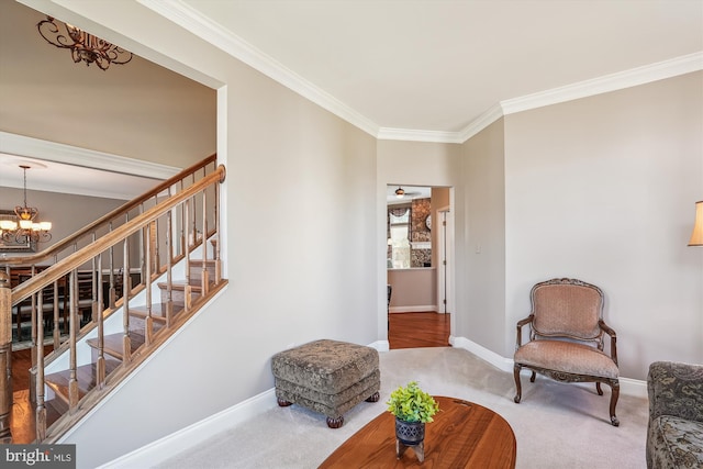 sitting room featuring stairway, carpet floors, crown molding, baseboards, and a chandelier