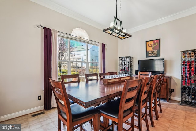 dining area featuring light tile patterned flooring, visible vents, crown molding, and baseboards