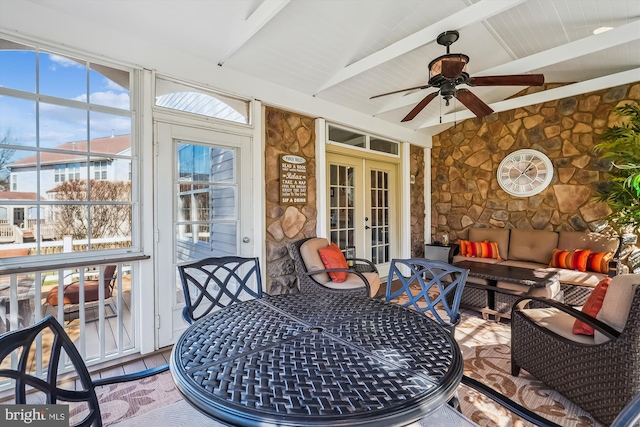 sunroom / solarium with french doors, vaulted ceiling with beams, and a ceiling fan