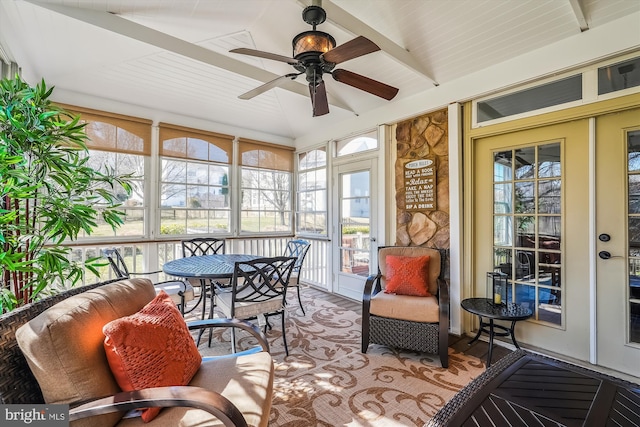 sunroom featuring lofted ceiling with beams and ceiling fan