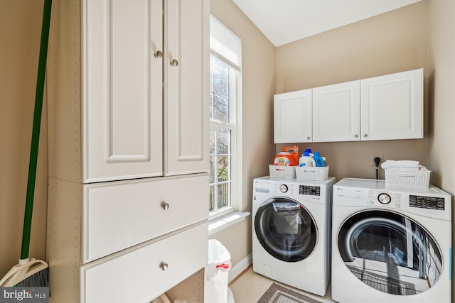 laundry area with baseboards, cabinet space, and washing machine and clothes dryer