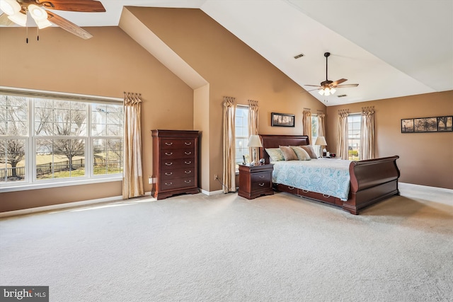 unfurnished bedroom with baseboards, high vaulted ceiling, carpet, and a ceiling fan