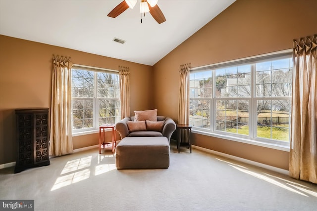 living area with visible vents, baseboards, carpet, and ceiling fan