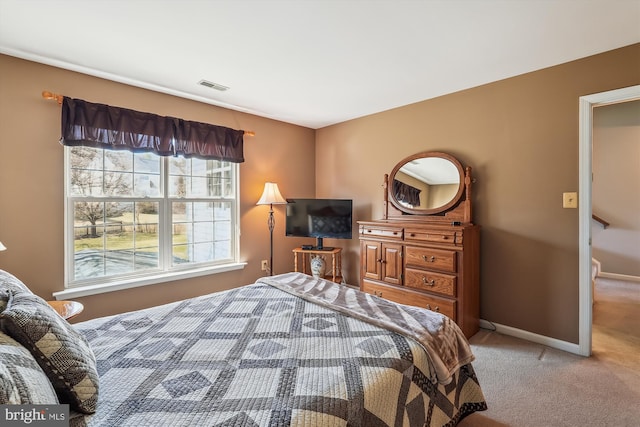 bedroom with carpet, visible vents, and baseboards