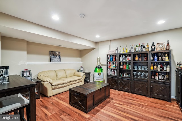 living area with recessed lighting and wood finished floors