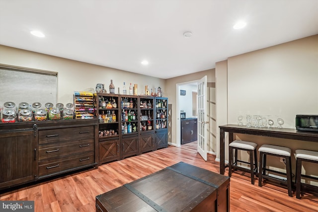 bar with recessed lighting, wood finished floors, and black microwave