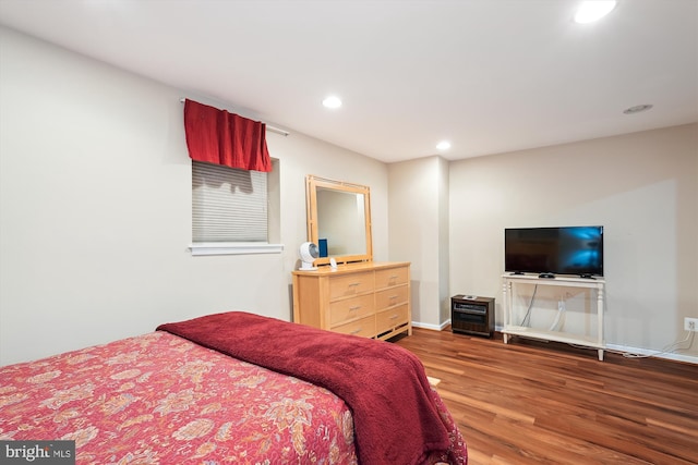 bedroom with recessed lighting, baseboards, and wood finished floors