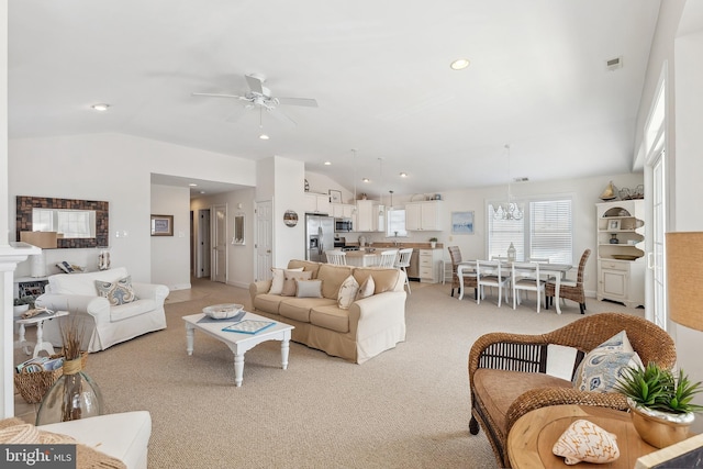 living room featuring visible vents, vaulted ceiling, light carpet, recessed lighting, and ceiling fan with notable chandelier