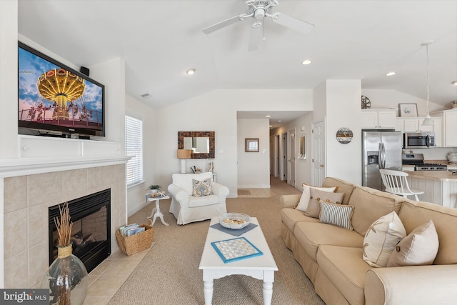 living area with light carpet, a tiled fireplace, recessed lighting, ceiling fan, and vaulted ceiling