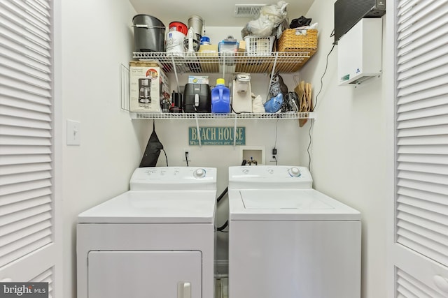 washroom with washer and dryer, laundry area, and visible vents