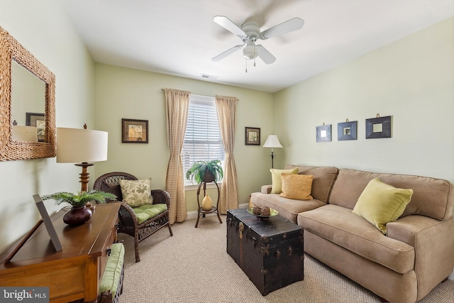 carpeted living area featuring baseboards, visible vents, and ceiling fan