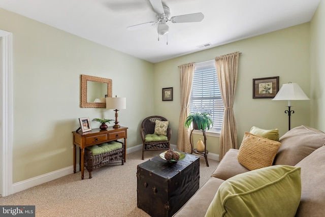 living area featuring visible vents, a ceiling fan, baseboards, and light carpet