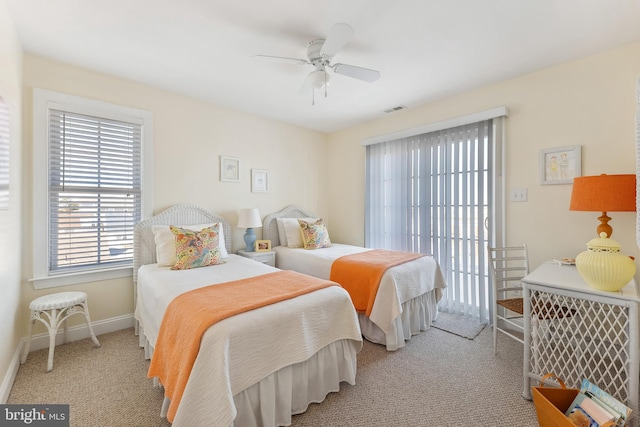 carpeted bedroom featuring baseboards, visible vents, and ceiling fan