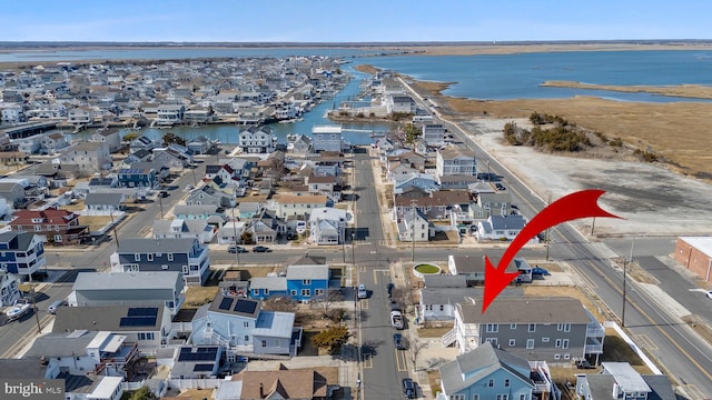 birds eye view of property featuring a residential view and a water view