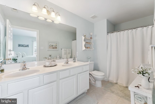 full bath featuring a sink, toilet, double vanity, and tile patterned flooring