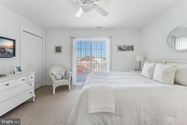 bedroom featuring access to exterior, visible vents, ceiling fan, light carpet, and a closet