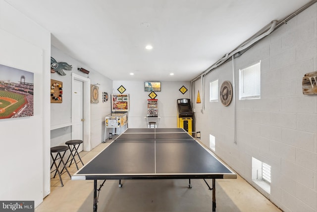 recreation room with recessed lighting and concrete block wall