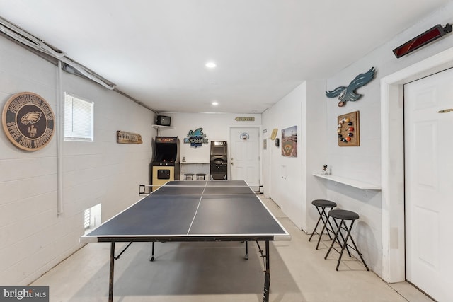 game room with recessed lighting, concrete floors, and concrete block wall