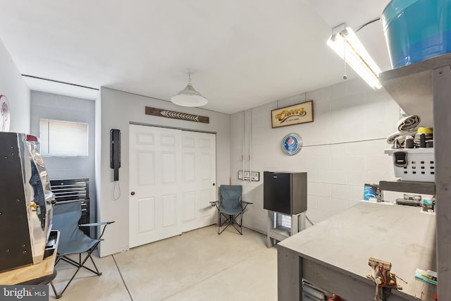 office with concrete block wall and finished concrete floors