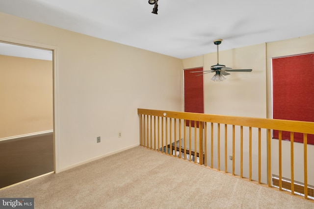 empty room with baseboards, a ceiling fan, and carpet floors