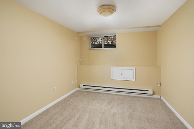 empty room with carpet flooring, baseboards, and baseboard heating