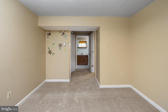 carpeted spare room with baseboards