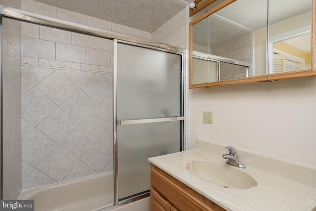 bathroom featuring enclosed tub / shower combo and vanity