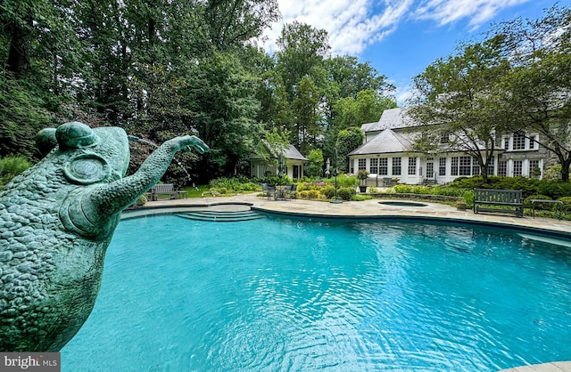 pool featuring a patio area and a hot tub