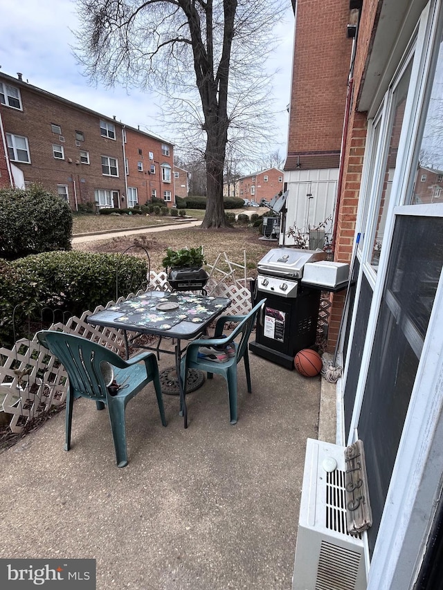 view of patio with outdoor dining area and a grill