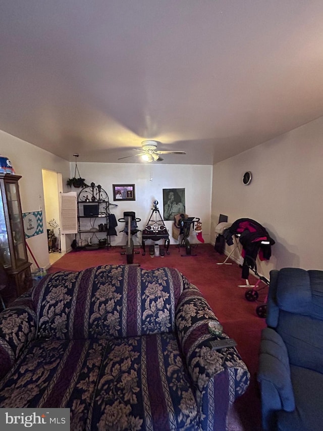 carpeted living area with a ceiling fan