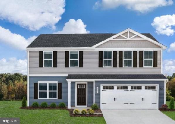 view of front facade featuring a garage, a front lawn, and driveway