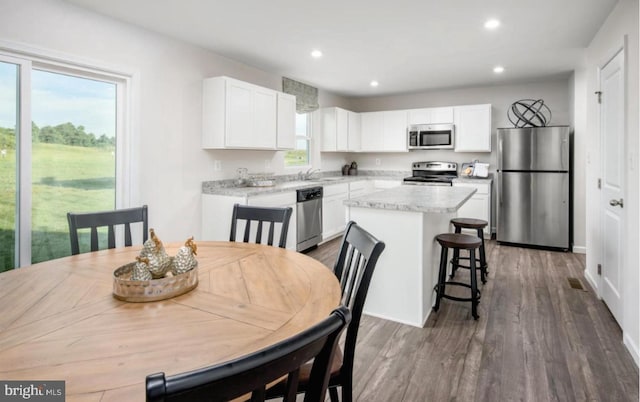 dining area featuring dark wood-style floors and recessed lighting