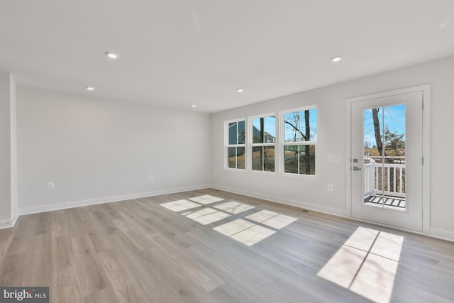 unfurnished room featuring recessed lighting, baseboards, and light wood finished floors