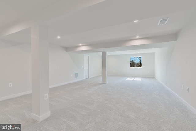 basement with light colored carpet, recessed lighting, visible vents, and baseboards