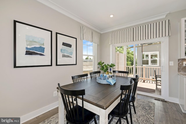 dining space featuring visible vents, baseboards, ornamental molding, recessed lighting, and wood finished floors