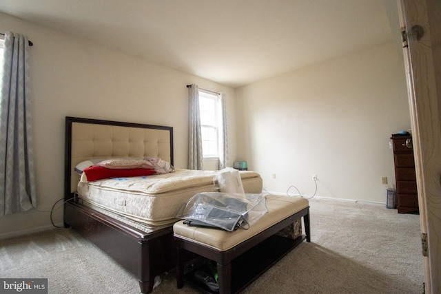 bedroom featuring carpet flooring and baseboards