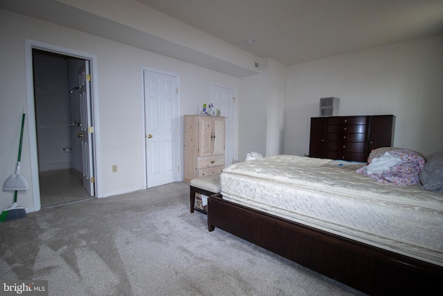 carpeted bedroom with connected bathroom