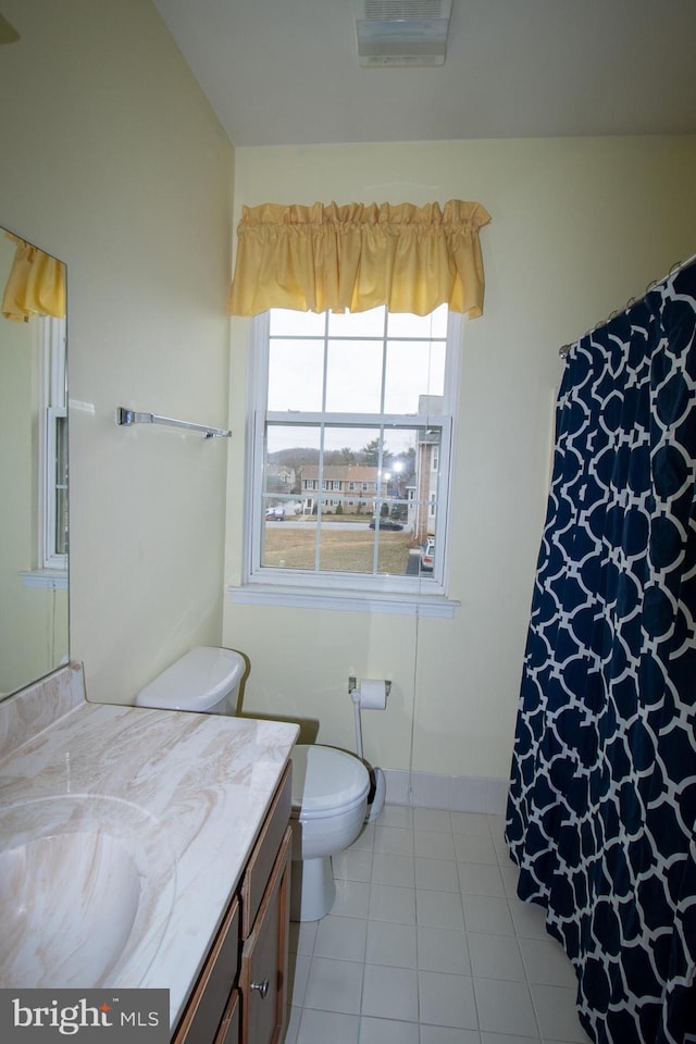 bathroom featuring tile patterned floors, curtained shower, toilet, and vanity