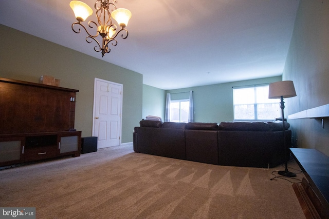 carpeted living area featuring an inviting chandelier