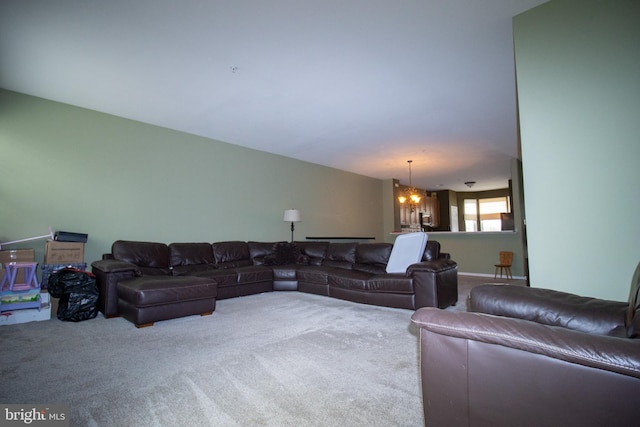 carpeted living area with a chandelier