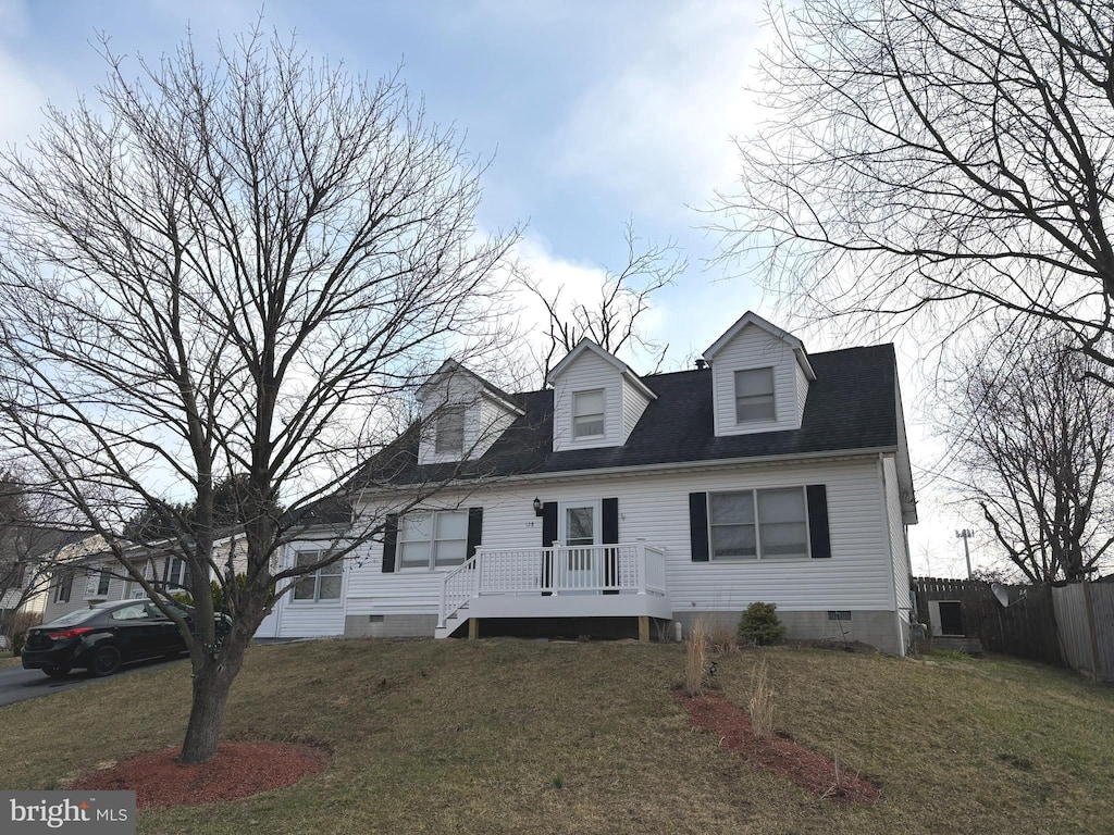 cape cod-style house with a deck, a front lawn, fence, and crawl space